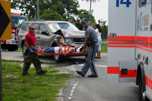 car accident injury, victim taken away on stretcher